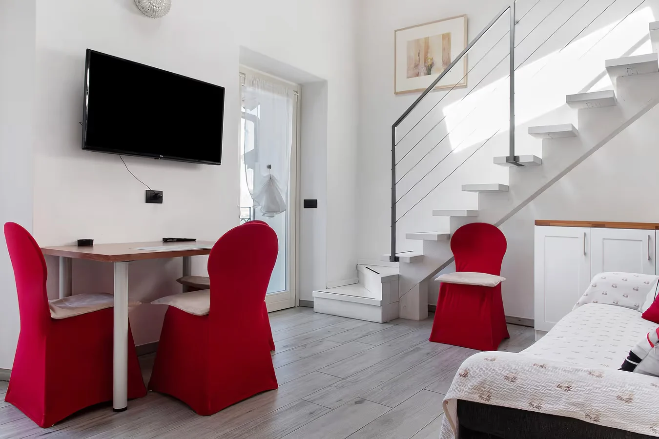 Camelia living area with its staircase and dining table